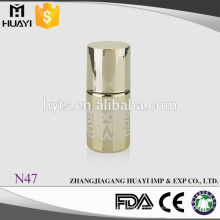 gold gel nail polish bottle with gold cap and brush